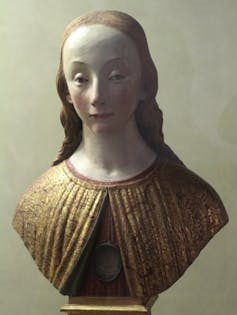 Statue bust of a woman's head and shoulders.