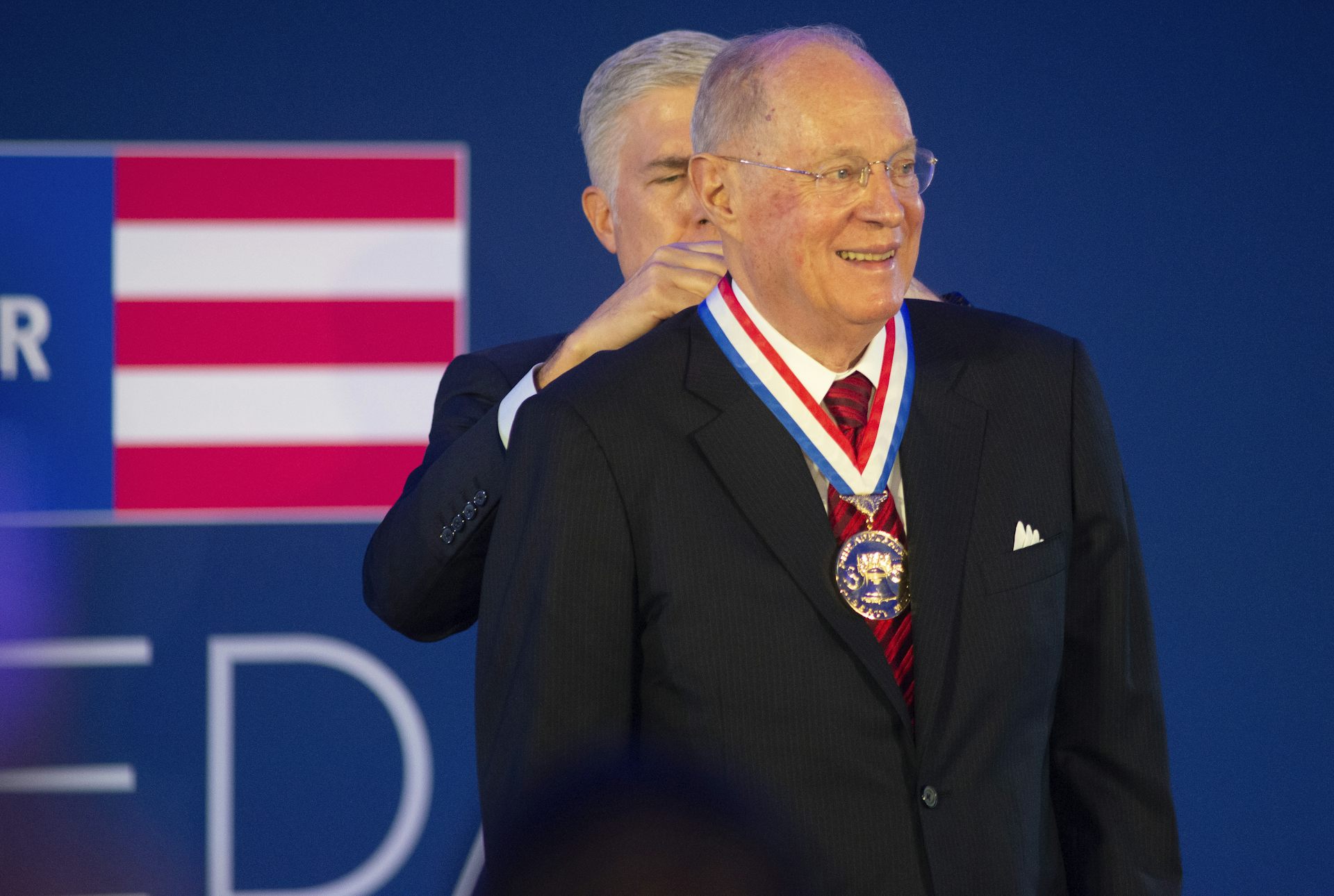 Supreme Court Justice Anthony Kennedy is presented a medal.