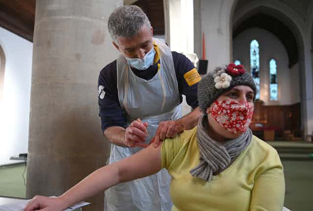 A woman getting vaccinated