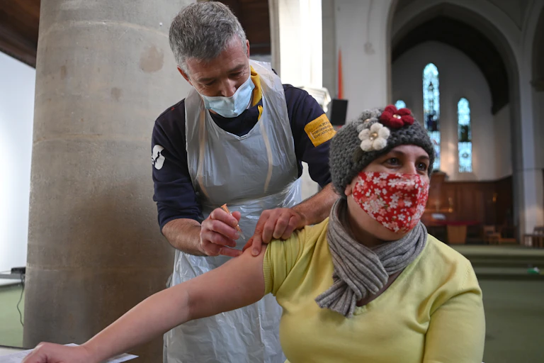 A woman getting vaccinated