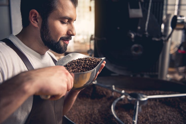 Man smelling coffee beans.