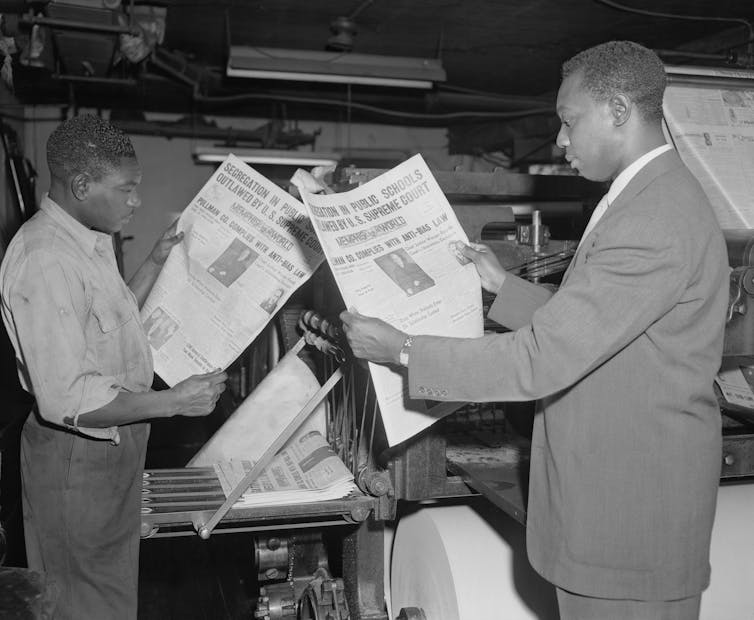 Black journalists read papers touting decision in Brown v. Board