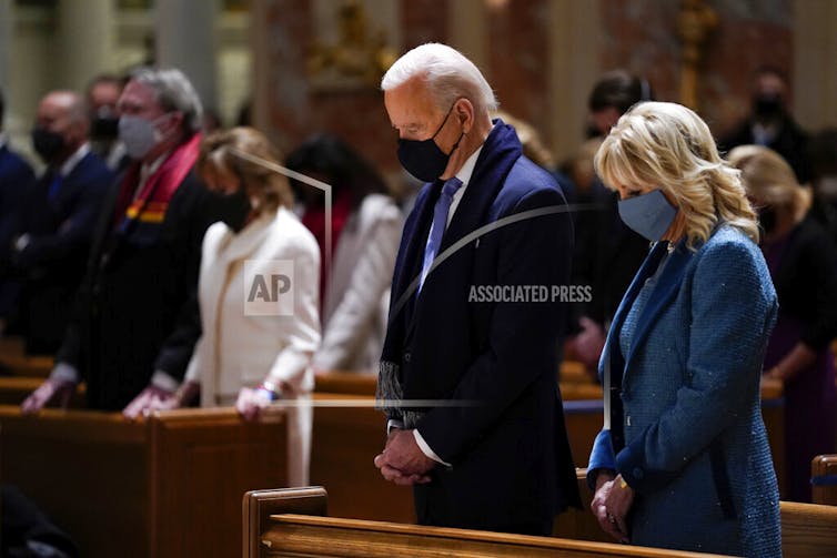 In a Jan. 20, 2021 photo, President-elect Joe Biden and his wife, Jill Biden, attend Mass at the Cathedral of St. Matthew the Apostle during Inauguration Day ceremonies in Washington.