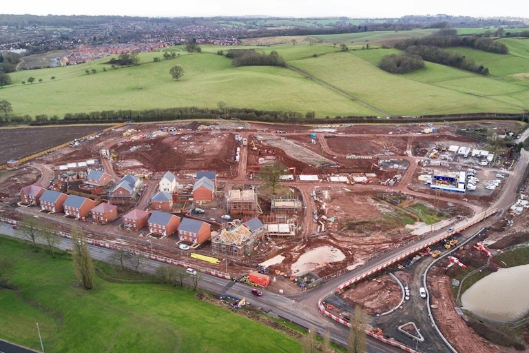 Photo An overhead view of a new development surrounded by green fields