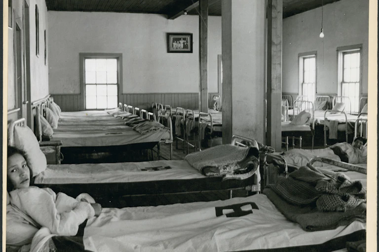Two girls lay in bed