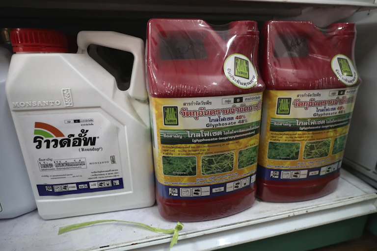 Plastic jugs of weed killer .
