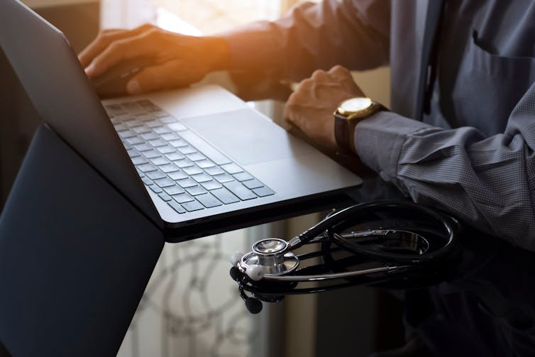 A doctor using a laptop.