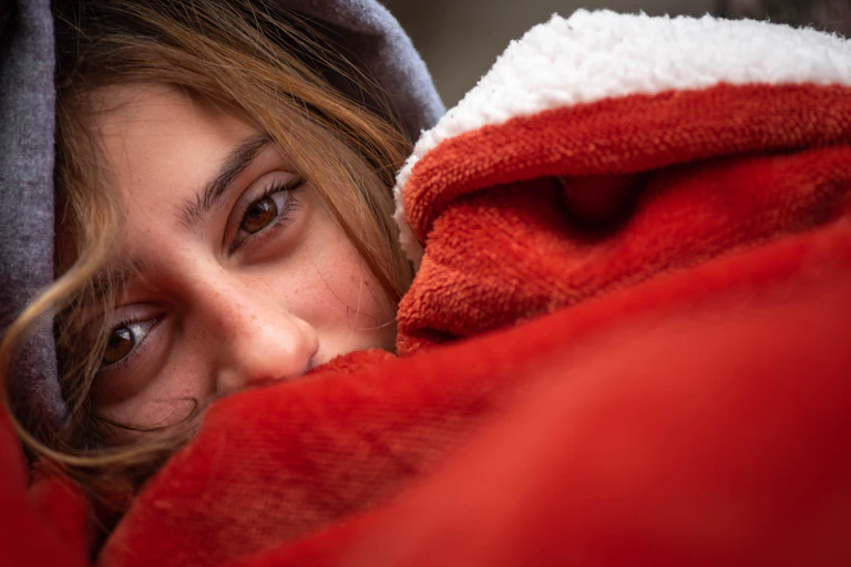 girl rugged up in fleece blanket
