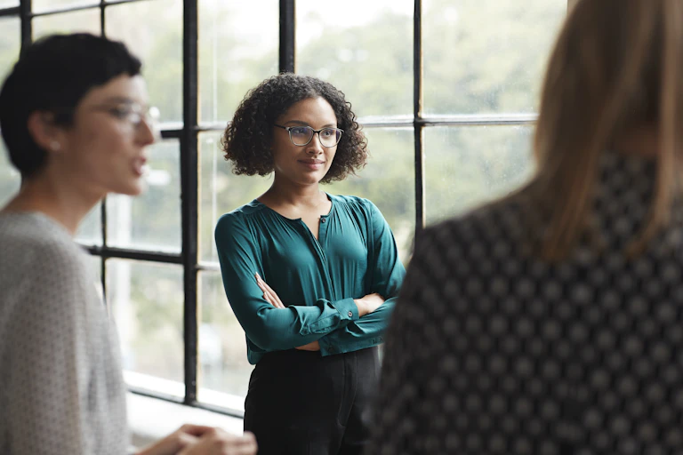 woman crosses arms and skeptically listens