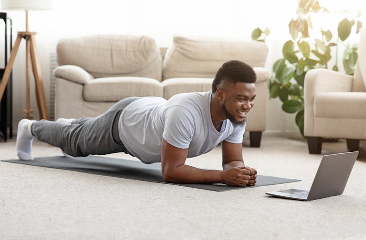 Man doing yoga at home