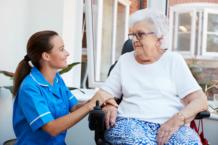 An aged-care worker with an elderly woman.