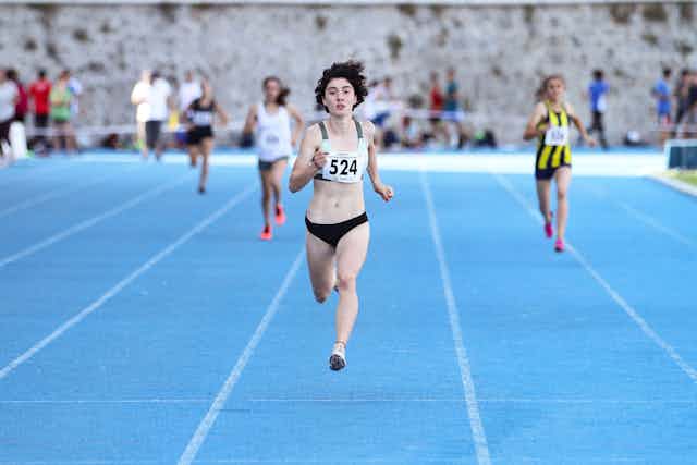 Women race on a blue track