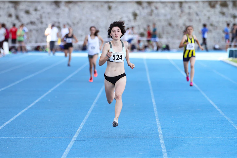 Women race on a blue track