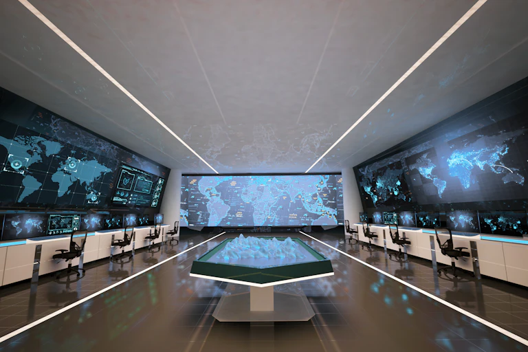An empty control room with three large screens and a holographic table