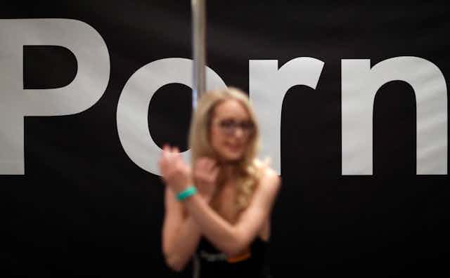 Porn actress Ginger Banks stands in the Pornhub booth during the AVN Adult Entertainment Expo in Las Vegas in 2018