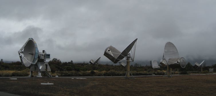A group of satellite dishes pointing in various directions.