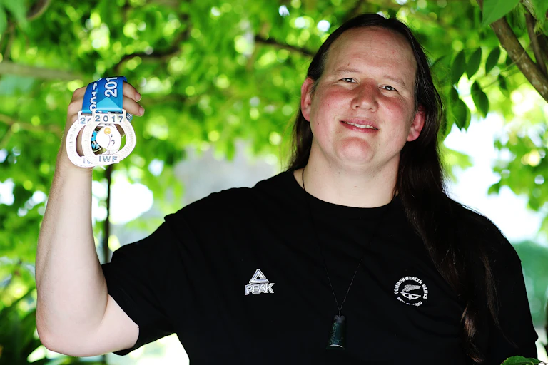 Laurel Hubbard holding up medals