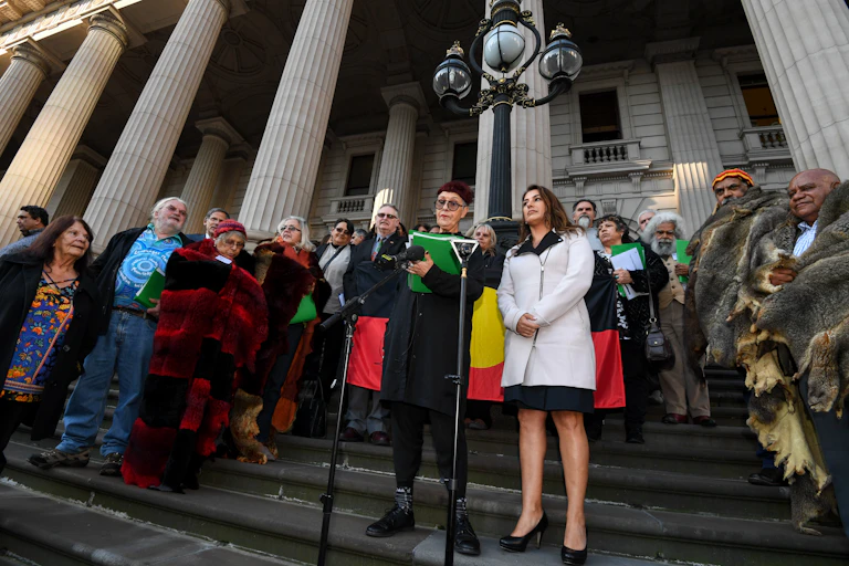 People stand in front of parliament house