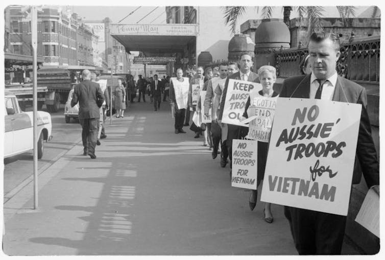 Man wears a placard reading 'No Aussie troops for Vietnam'