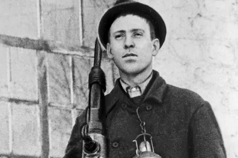 Miner holding a drill