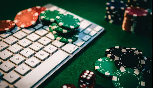 Keyboard surrounded by gambling chips.