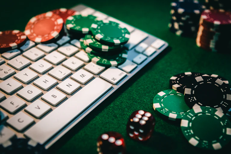 Keyboard surrounded by gambling chips.