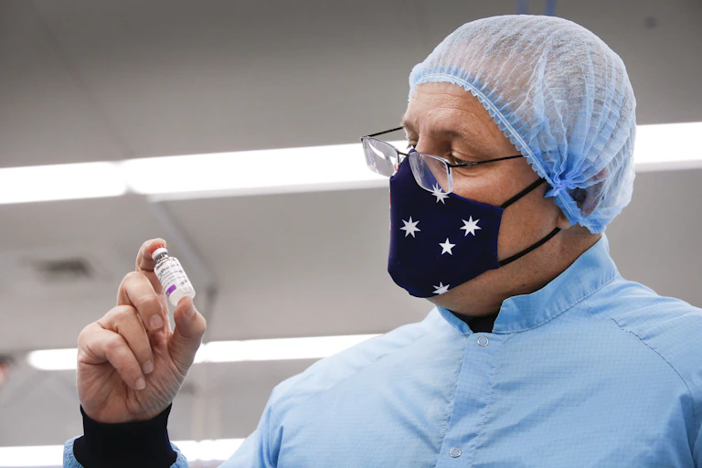Scott Morrison holding a vial of the AstraZeneca vaccine