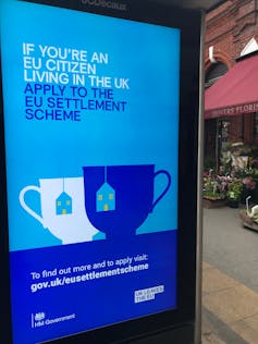 An advertisement at a bus stop urging EU citizens living in the UK to apply for the settlement scheme.