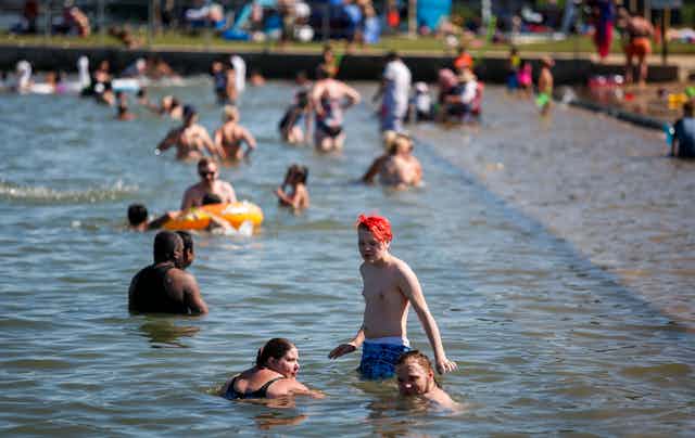 People wading in the water at a park.