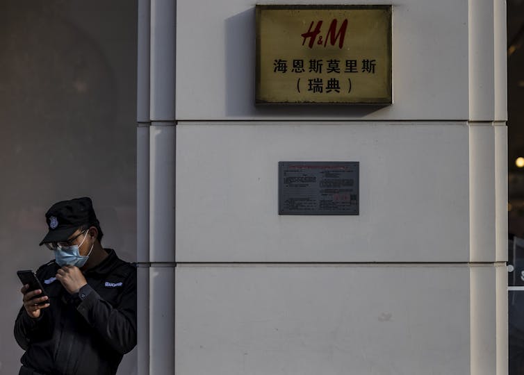 A security guard outside of an H&M store in Shanghai.