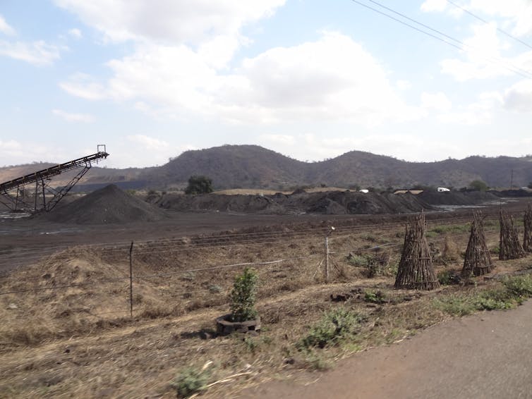 Hills and a coal mine under a bright sky