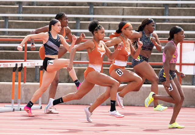 Several women run in a hurdles race 