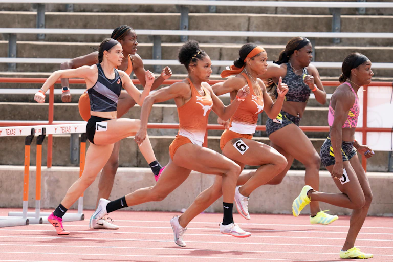 Several women run in a hurdles race