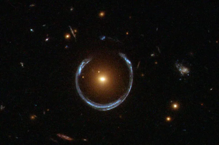 An image of a bright galaxy with a blue ring around it.