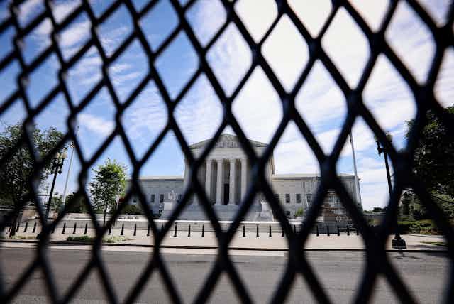 The U.S. Supreme Court is seen through security fencing