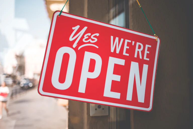 Shop sign saying 'Yes, we're open'