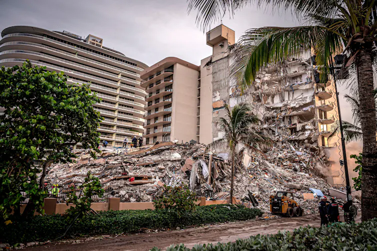 Front view of a collapsed apartment building.