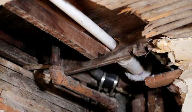 A lead pipe is exposed by a hole in the kitchen ceiling of a home in Newark, N.J. 