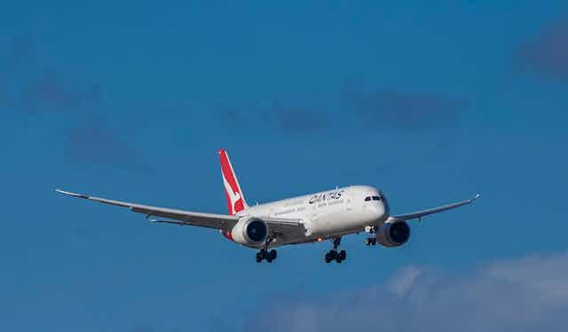 Qantas plane in sky.