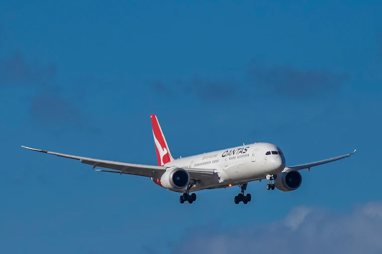 Qantas plane in sky.