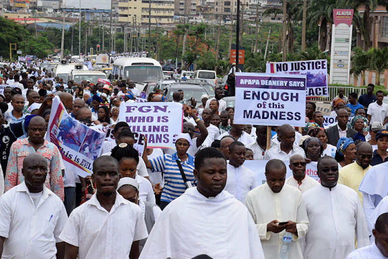 People raising placards and protesting against violence and killings in Benue state.