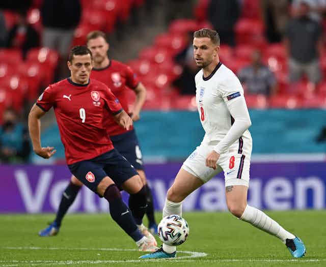 England footballer Jordan Henderson about to be tackled by Tomas Holes of the Czech Republic