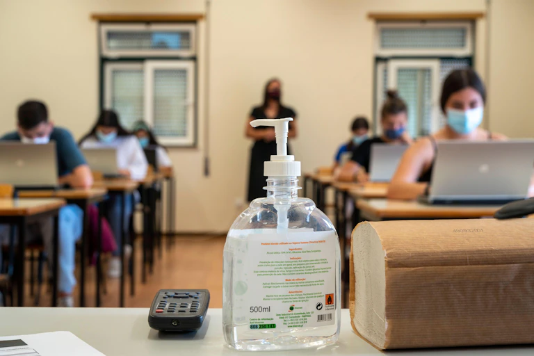 High school class with bottle of hand gel in foreground