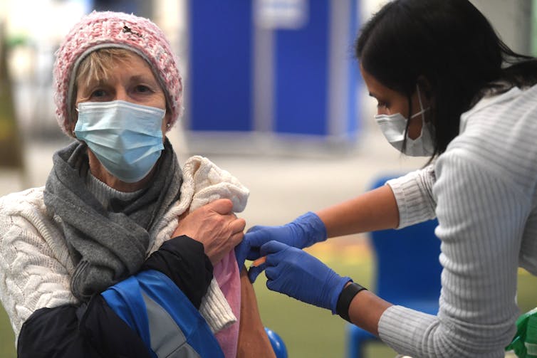 A woman receiving a COVID vaccine.