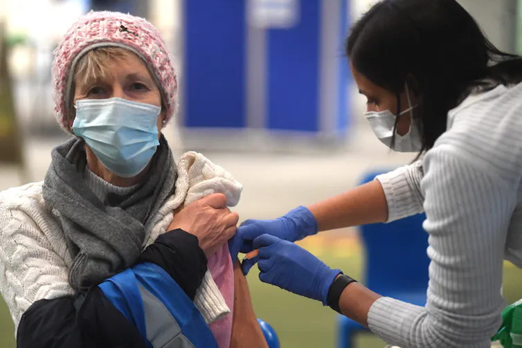 A woman receiving a COVID vaccine.