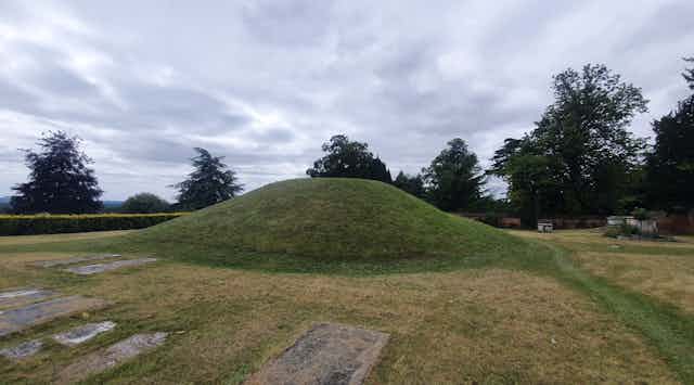 A burial mound surrounded by graves