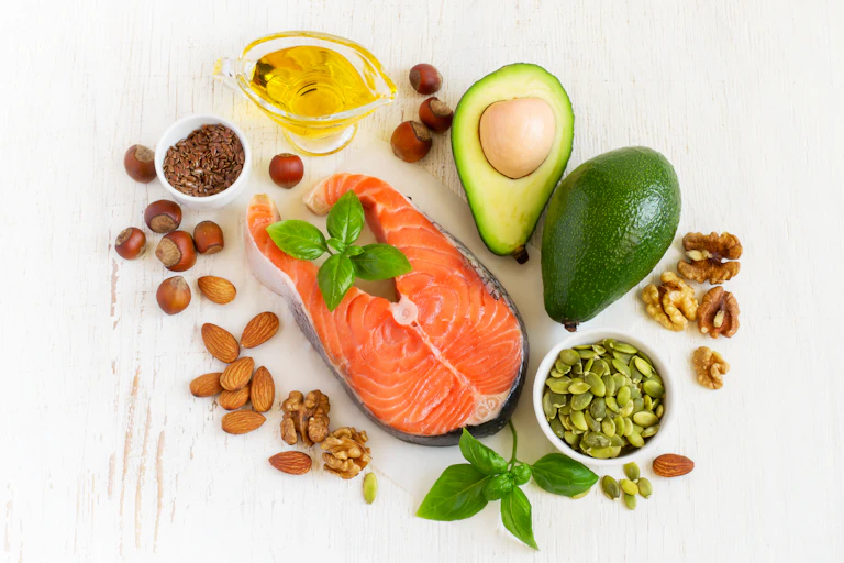 An overview of foods that contain healthy fat, such as salmon, almonds, olive oil, and avocado.