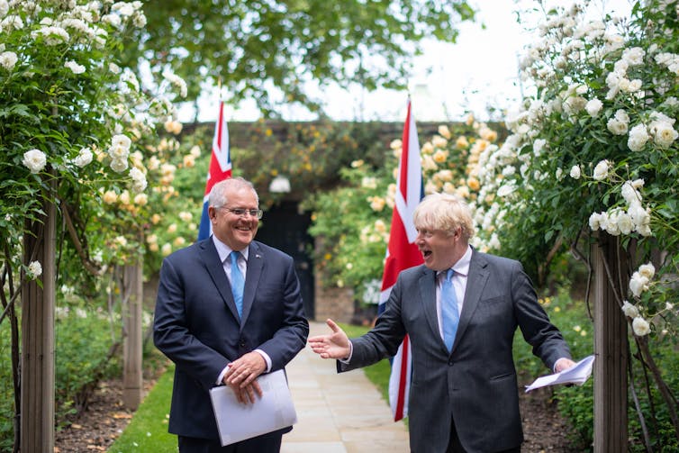 Boris Johnson and Scott Morrison in a garden having a joke