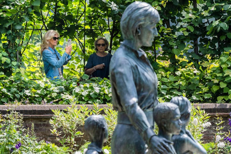 Statue of Diana, Princess of Wales with three unidentified children at Highgrove, the Spencer family seat.