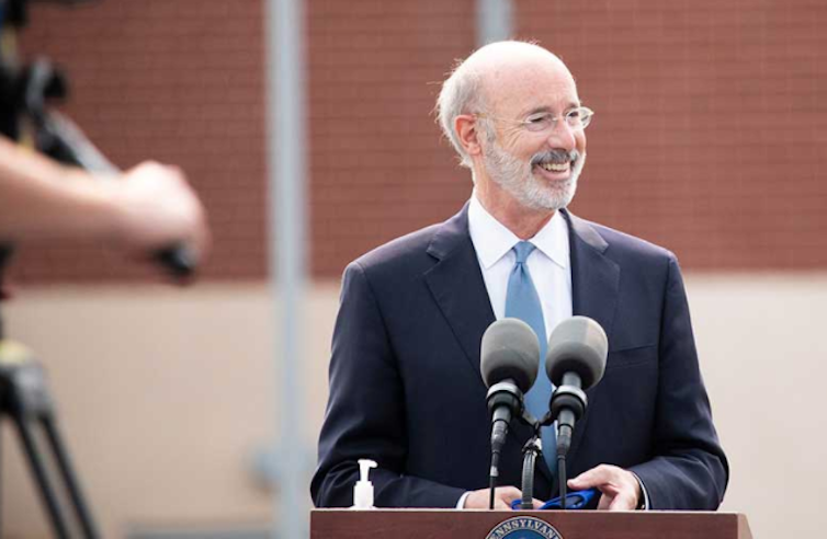 Pennsylvania Gov. Tom Wolf, standing behind a microphone at a podium.